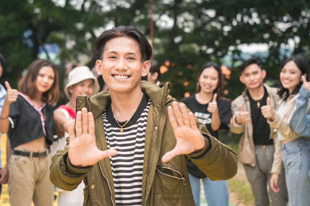 A,popular,guy,posing,in,front,of,his,friends,in