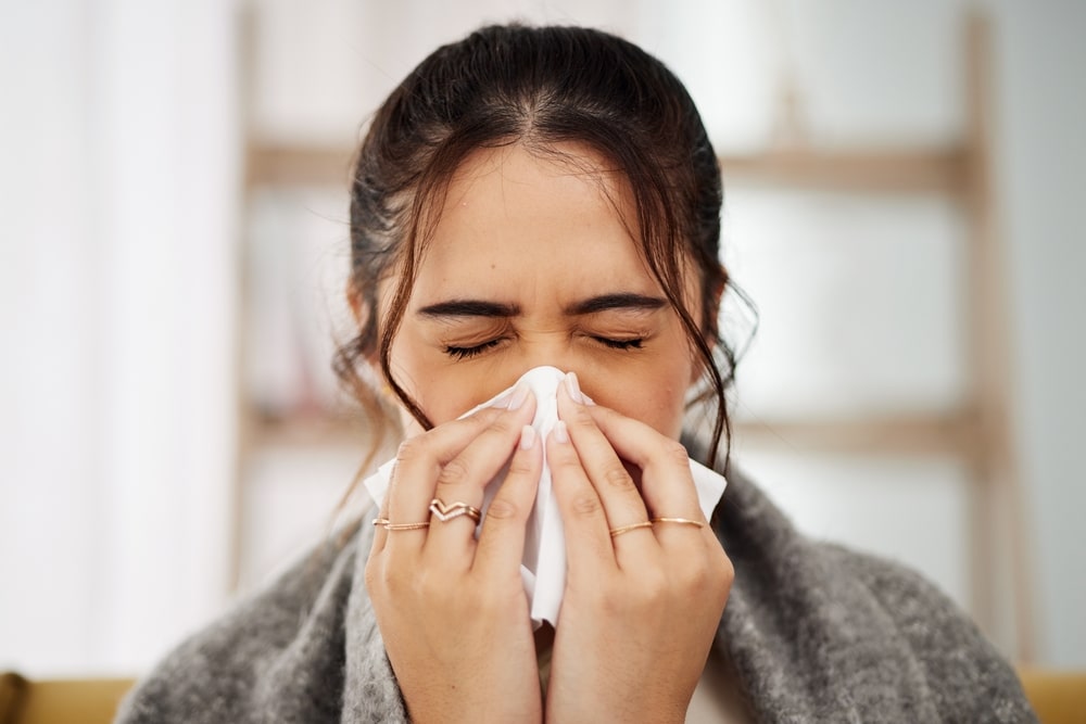 Tissue,,nose,and,sick,woman,sneezing,in,living,room,with