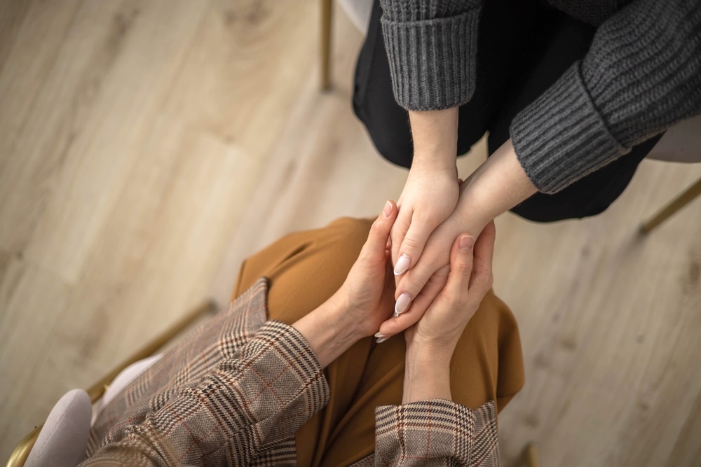 Two,woman,holding,hands,to,each,other,concept,of,support