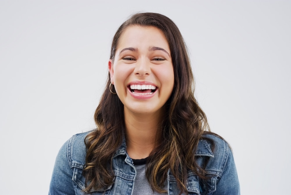 Portrait,,woman,and,happy,with,laugh,by,studio,background,for